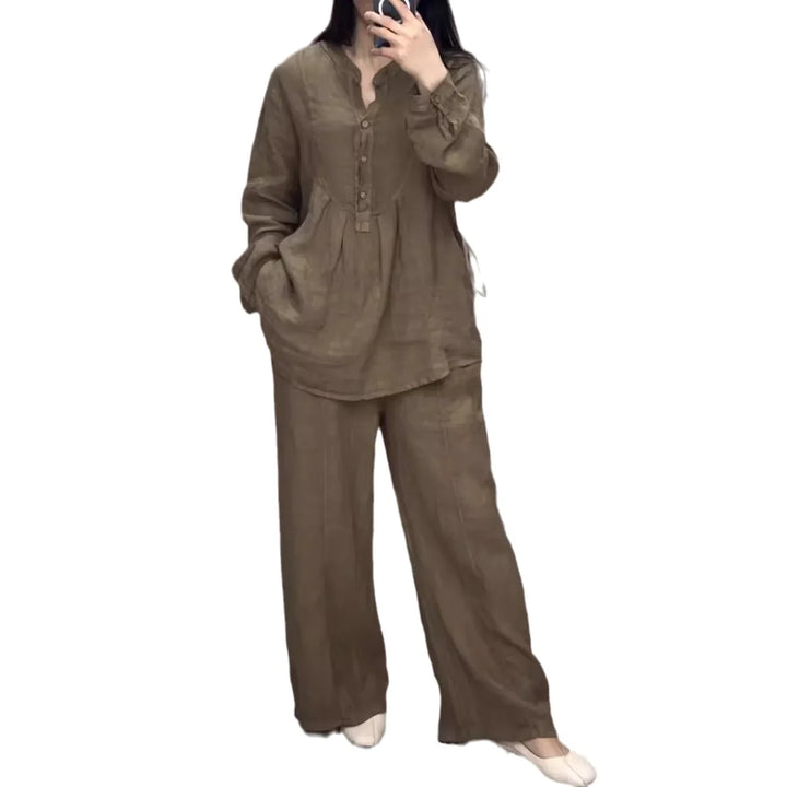 Woman wearing loose brown linen two-piece outfit with long sleeves and wide-leg pants