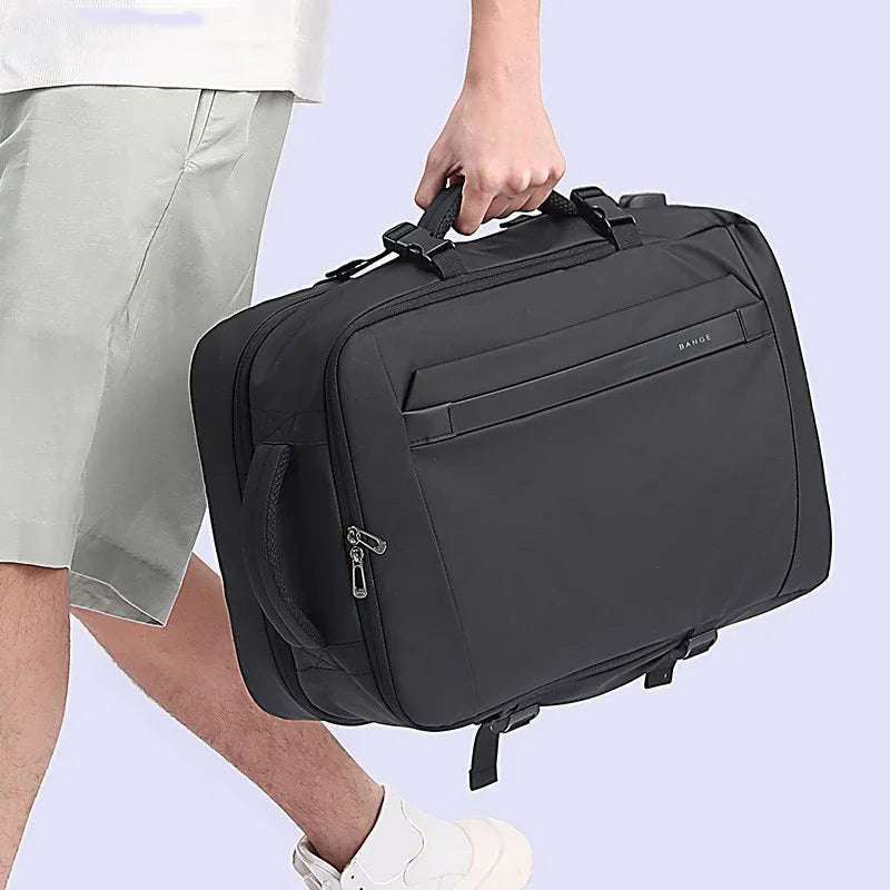 Person carrying black soft-sided travel bag with dual handles and zippered compartments