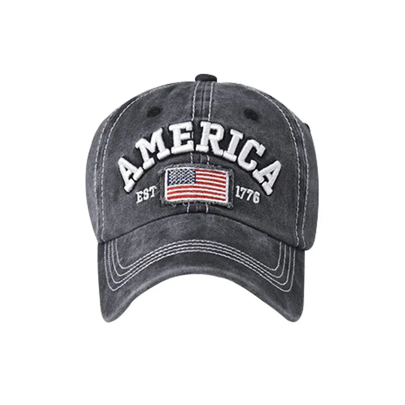 Dark gray baseball cap with embroidered American flag and text America EST 1776
