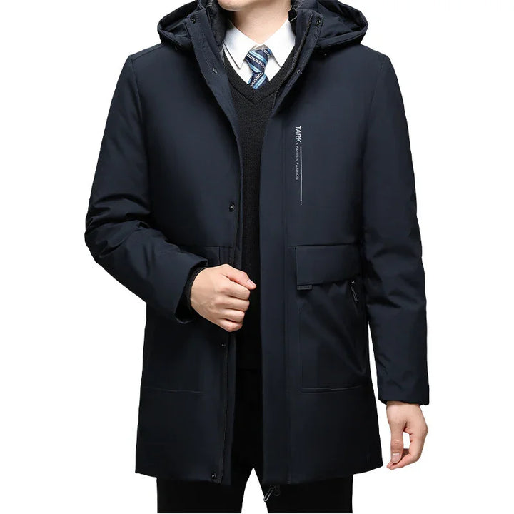 Men's black winter parka jacket with hood, zip and button closure, worn over suit and tie