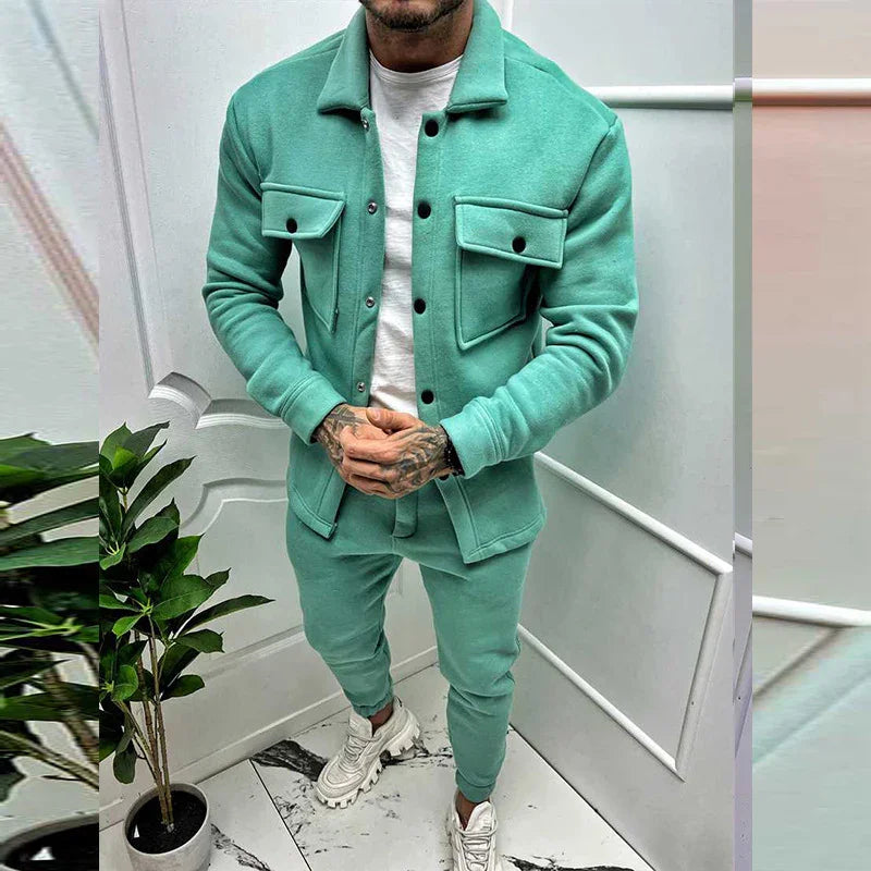 Man wearing mint green casual jacket and pants with white sneakers in white room