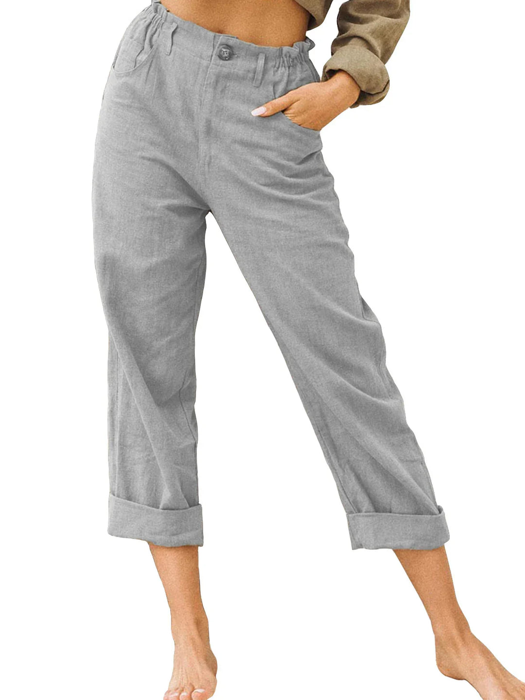 Woman wearing gray cuffed pants with elastic waistband and pockets, hand in pocket on white background