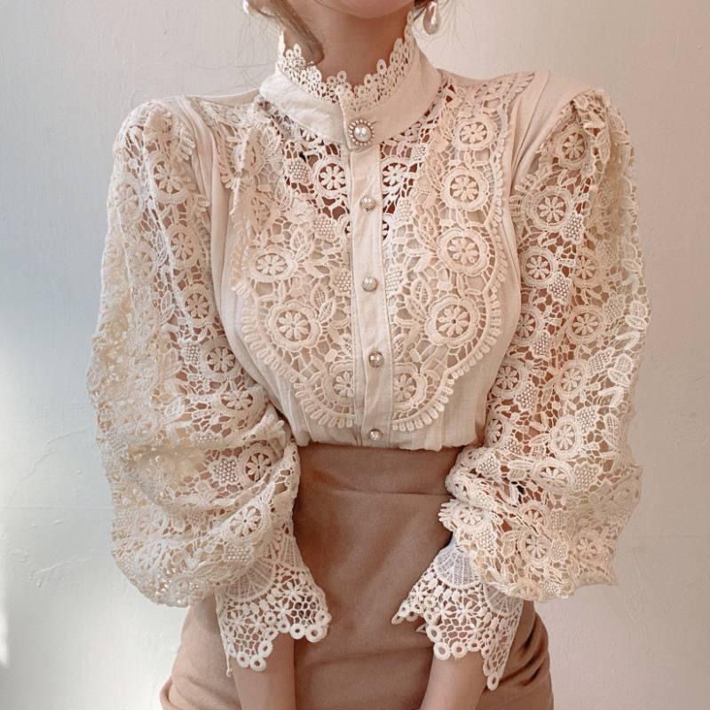 Woman wearing vintage cream lace blouse with pearl buttons and puffed sleeves