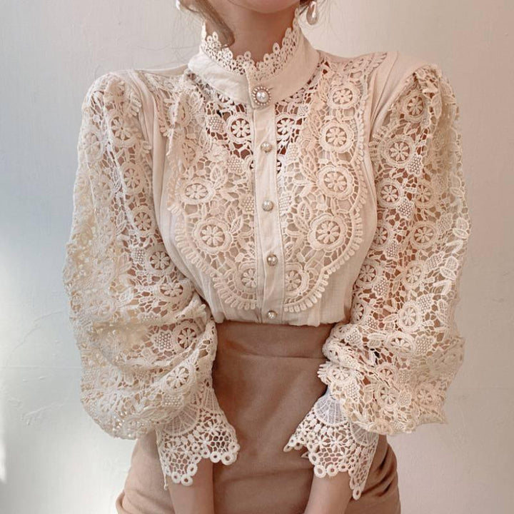 Woman wearing vintage cream lace blouse with pearl buttons and puffed sleeves