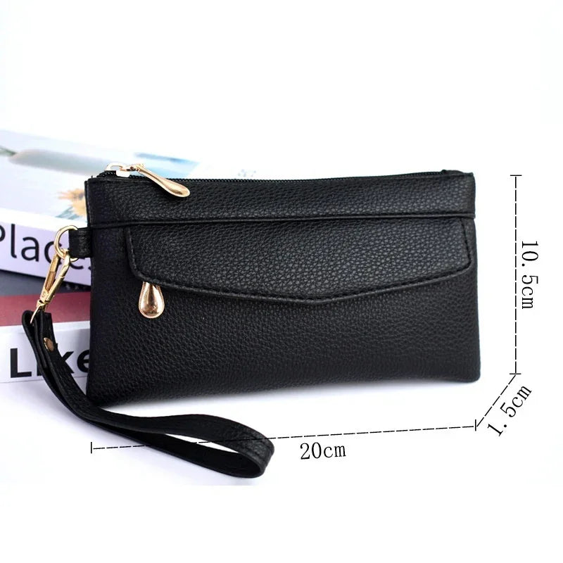 Black leather wristlet wallet with gold zipper and drop pendant, 20x10.5x1.5 cm size