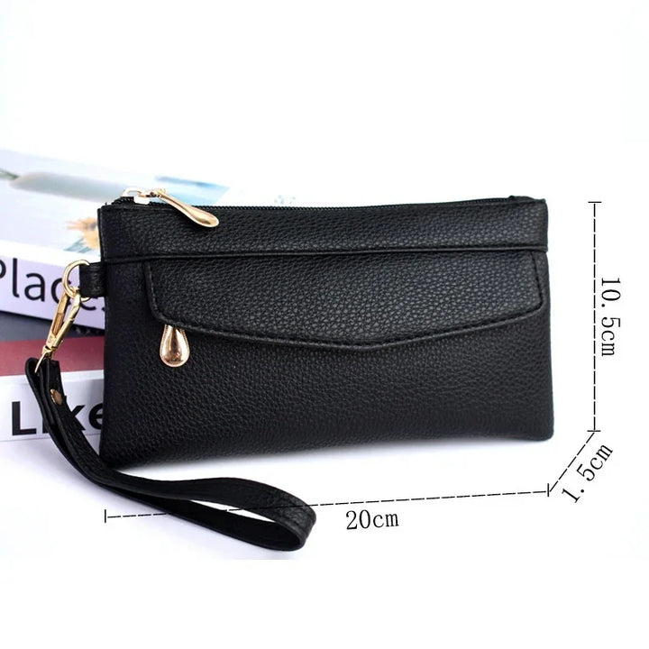 Black leather wristlet wallet with gold zipper and drop pendant, 20x10.5x1.5 cm size