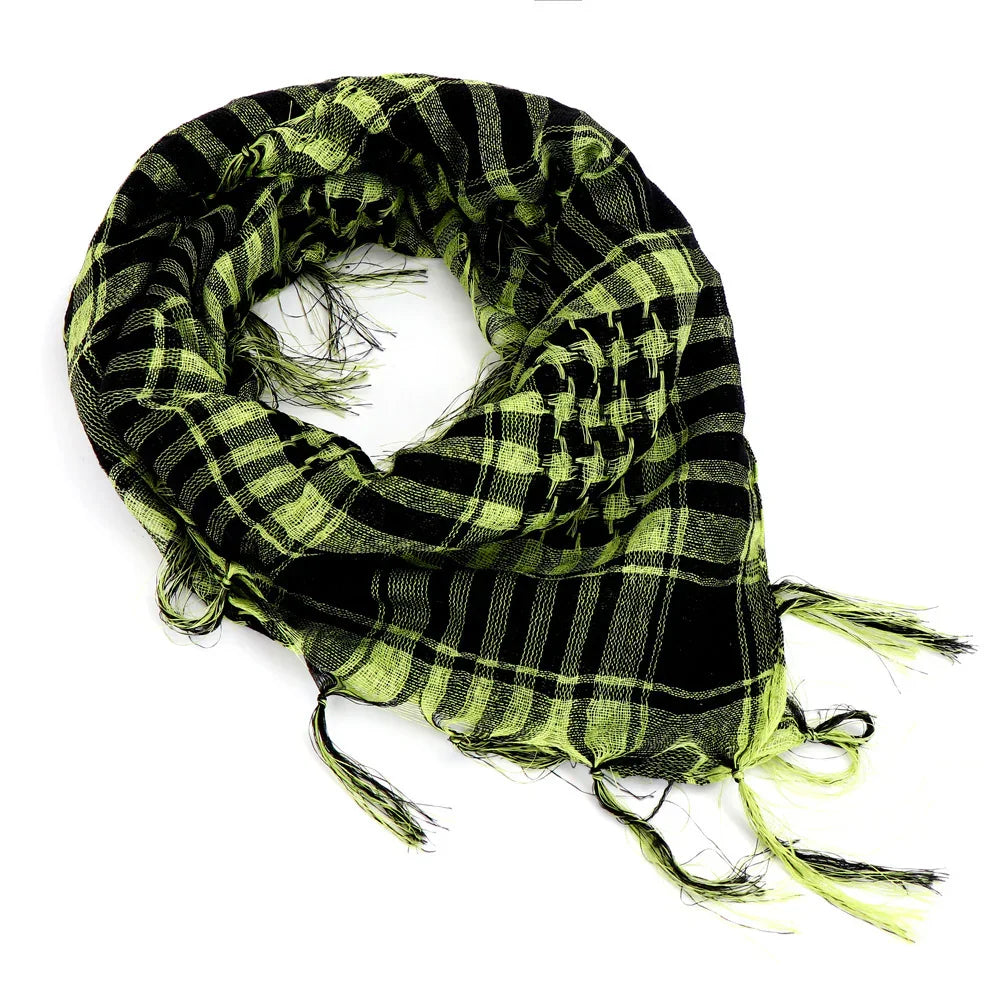 Black and neon green checkered scarf with fringed tassels, folded in a circular shape on white background