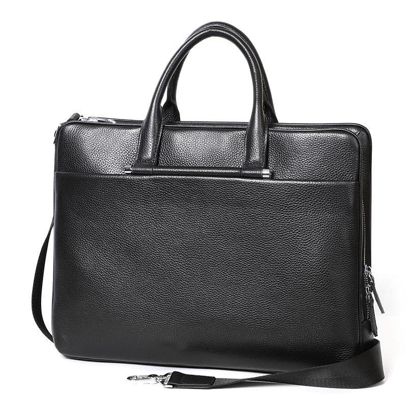 Black textured leather briefcase with handles and detachable shoulder strap on white background
