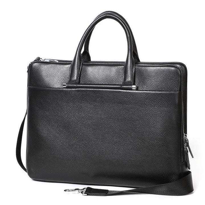 Black textured leather briefcase with handles and detachable shoulder strap on white background