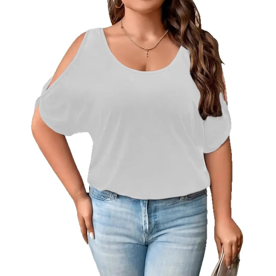 Woman wearing white cold shoulder top with scoop neckline and light blue jeans