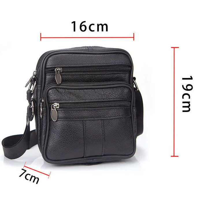Compact black leather crossbody bag with multiple zippered pockets and adjustable strap, dimensions 19x16x7 cm