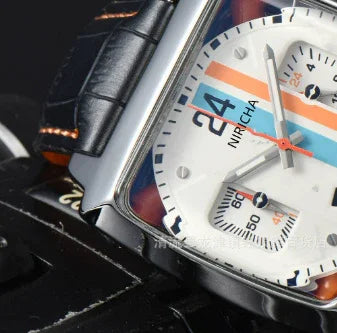 Close-up of a Nircha branded watch with a white dial, blue and orange racing stripes, and black leather strap