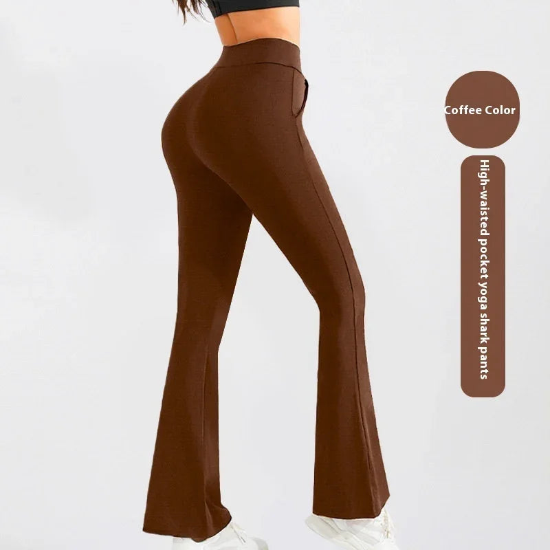 Woman wearing coffee color high-waisted pocket yoga shark pants with white sneakers on light background