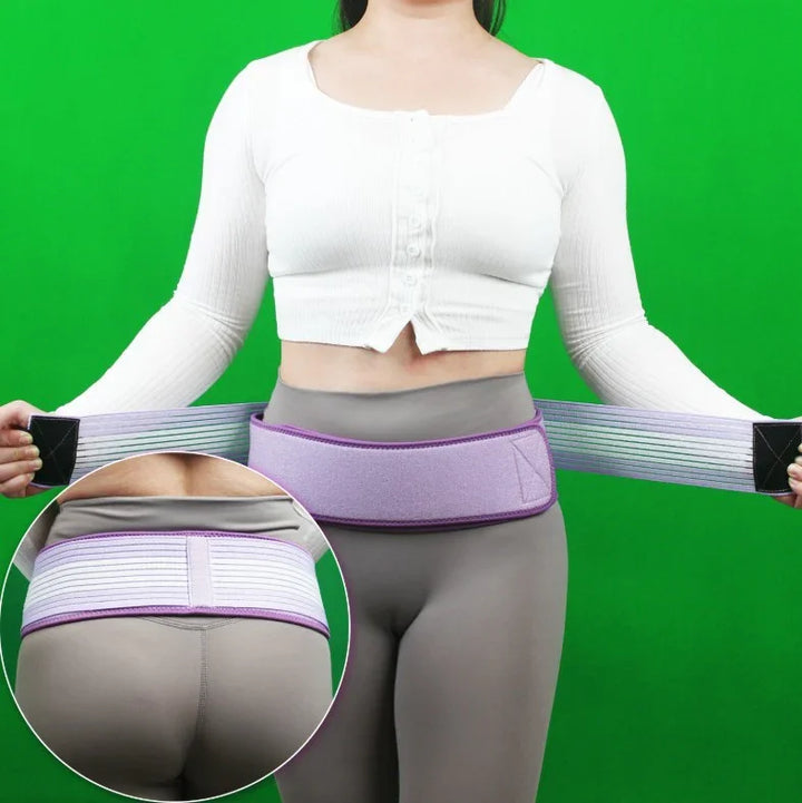 Woman wearing purple lumbar support belt over gray leggings against green background