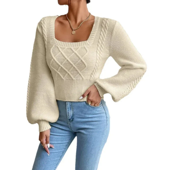 Woman wearing cream cable knit square neck sweater with balloon sleeves and light blue jeans