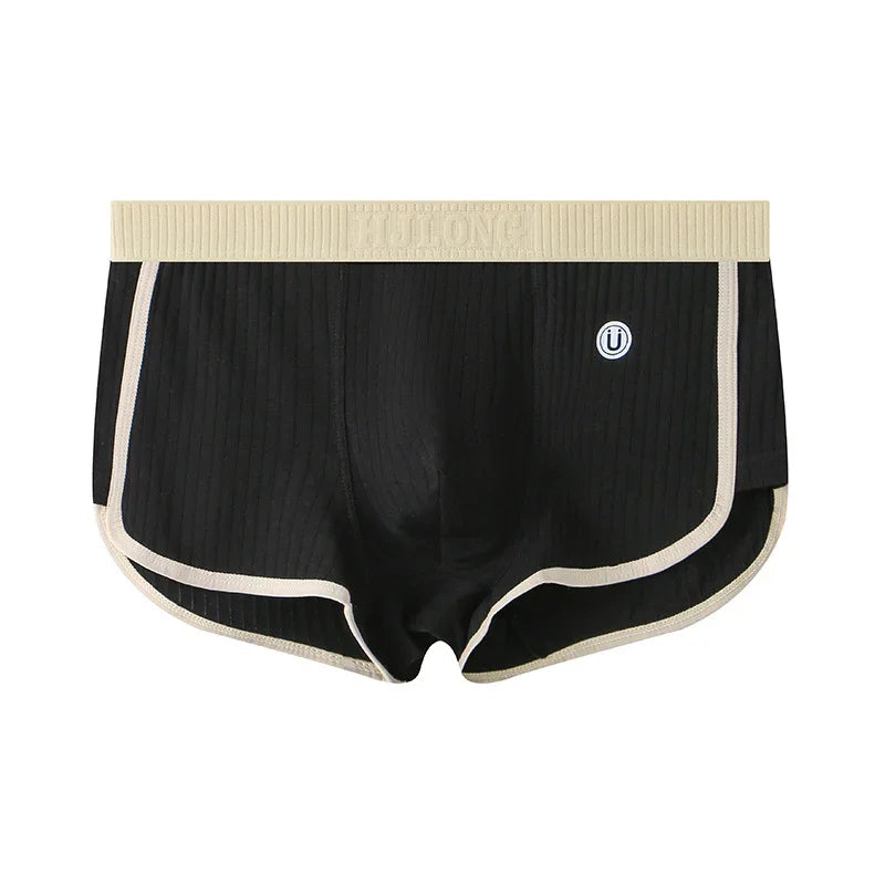 Black ribbed men's boxer briefs with beige waistband and trim, featuring a small circular logo