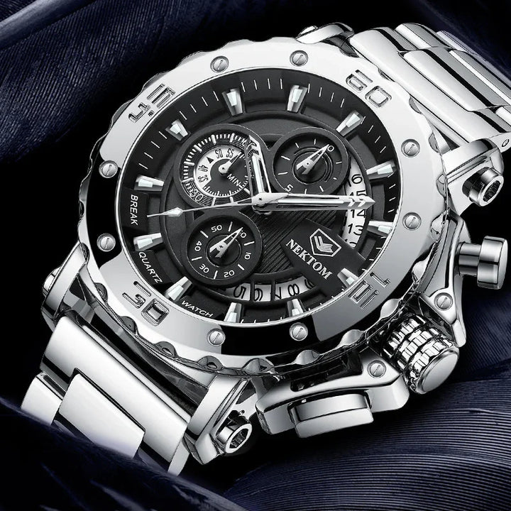Silver Nektom men's quartz chronograph watch with black dial and metal bracelet on dark fabric