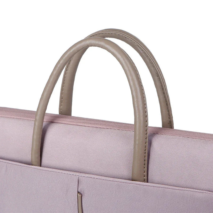 Close-up of beige leather handles on a light purple fabric handbag