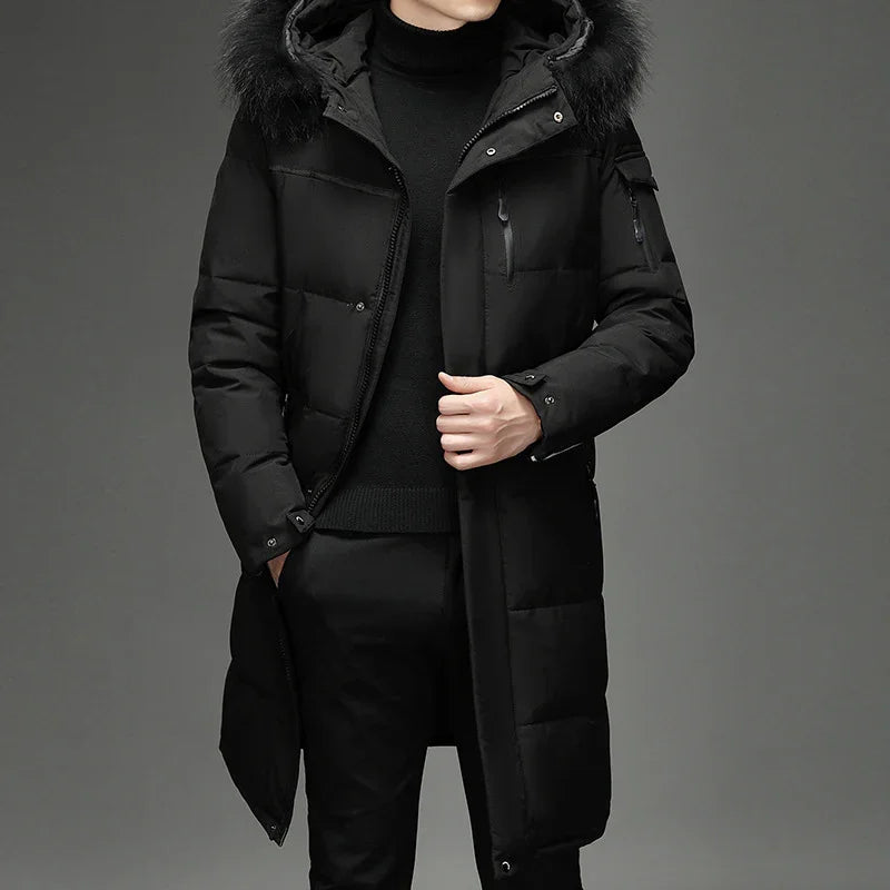 Man wearing a long black padded winter coat with fur hood and black turtleneck sweater