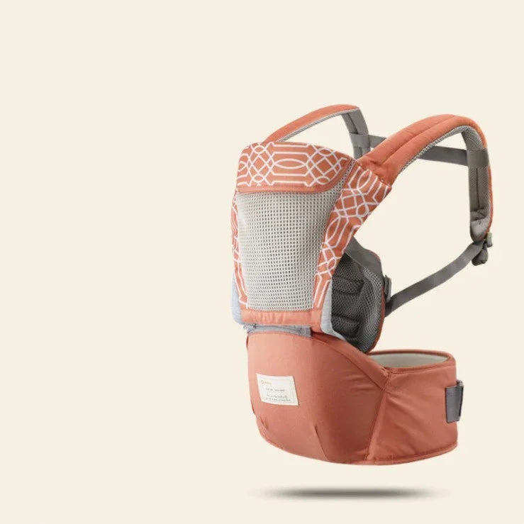 Ergonomic orange baby carrier with white geometric pattern and breathable mesh panel