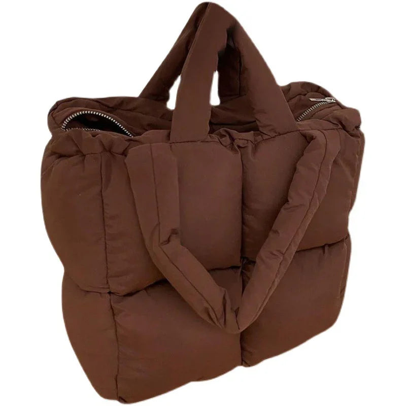 Brown padded tote bag with quilted design and short handles, zipper closure