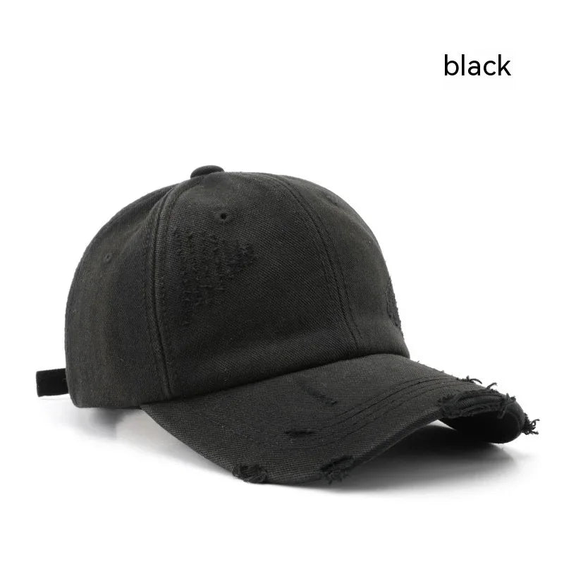 Black distressed baseball cap with curved brim and adjustable strap on white background