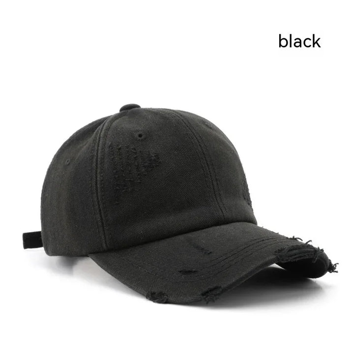 Black distressed baseball cap with curved brim and adjustable strap on white background