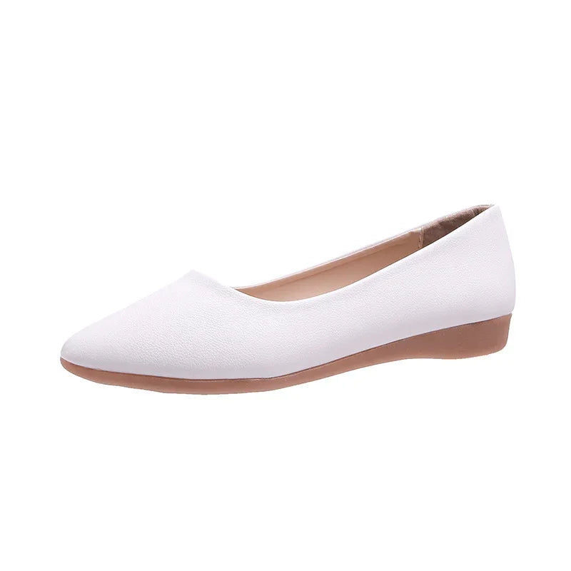 White women’s pointed toe flats with low brown sole on white background