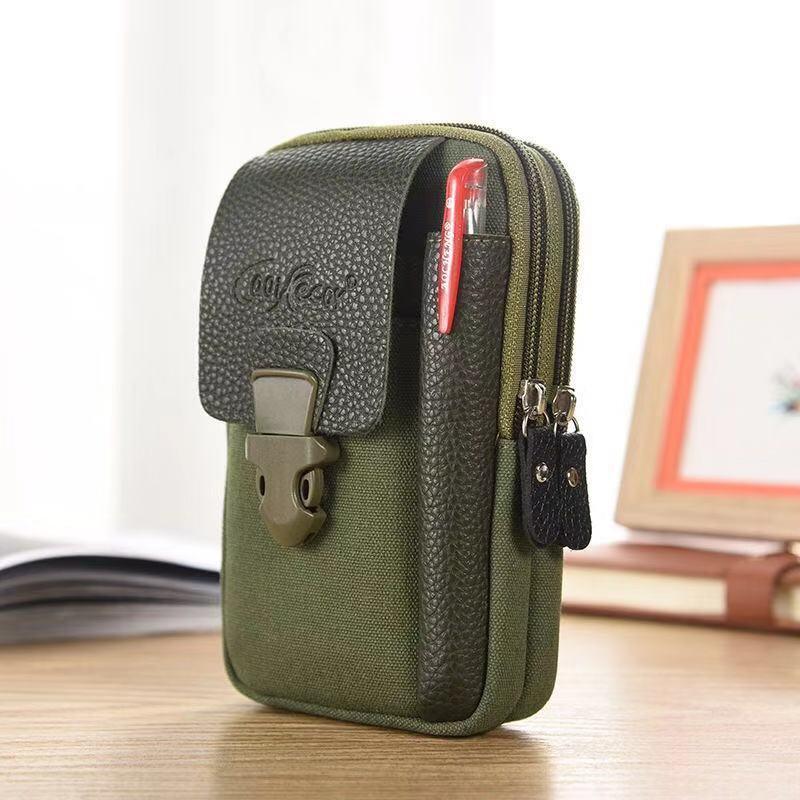 Compact olive green canvas and black leather multi-pocket pouch with pen holder and buckle clasp on wooden desk