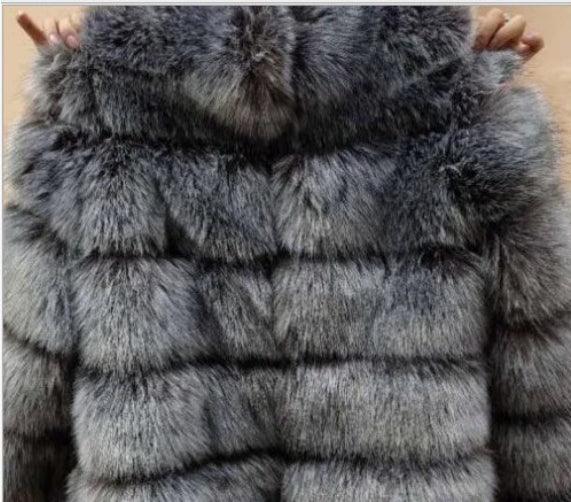 Luxurious gray fur coat with dense, soft texture displayed on wooden background