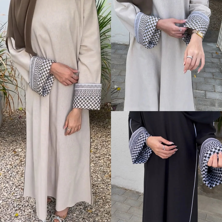 Women wearing abayas with patterned wide cuffs in beige and black, shown in outdoor settings
