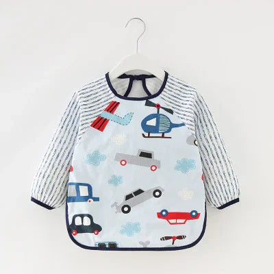 Toddler long-sleeve waterproof bib with striped sleeves and colorful transportation prints including cars and helicopters