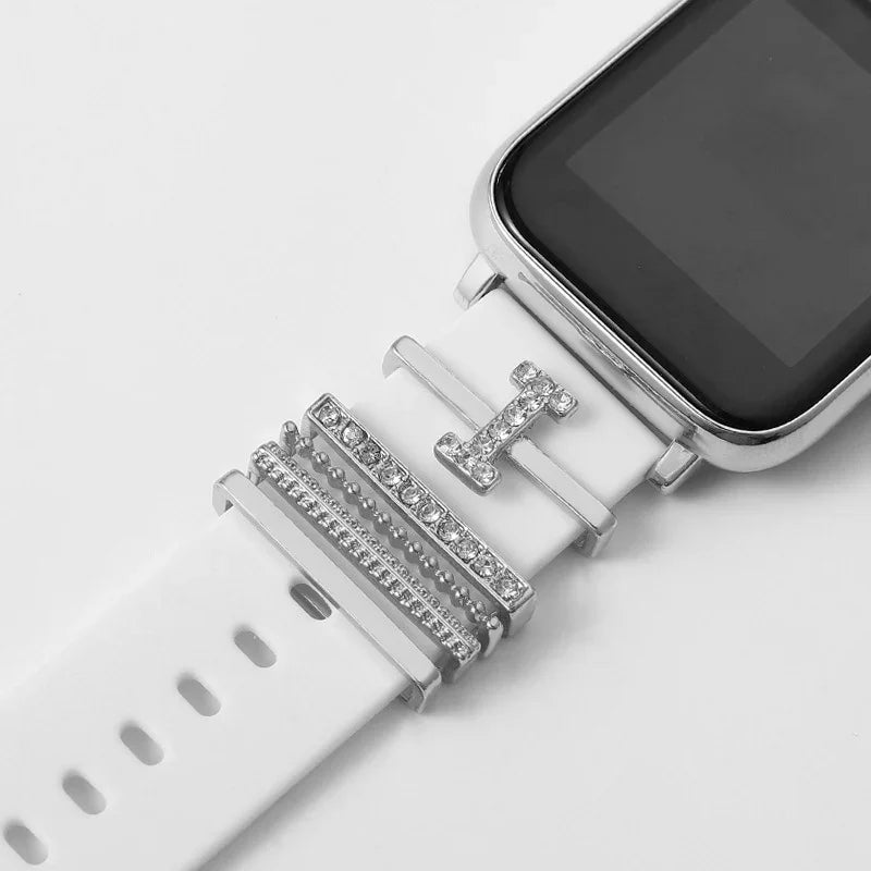 Close-up of white smartwatch strap with silver and rhinestone decorative charms