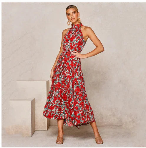 Woman wearing sleeveless red floral midi dress with high neckline and beige heels in minimalist setting