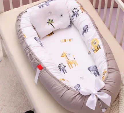 Baby nest with gray borders and white interior featuring cartoon zoo animals in a crib