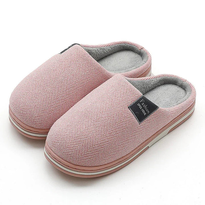 Pink herringbone pattern indoor slippers with gray plush lining and cushioned soles
