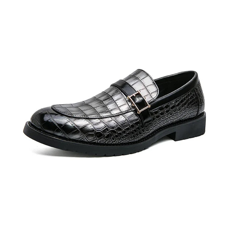 Black crocodile pattern leather men's formal loafer with decorative buckle on white background