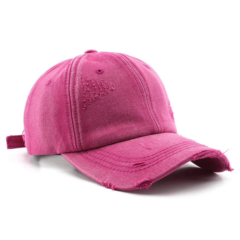 Pink distressed cotton baseball cap with curved brim and adjustable strap