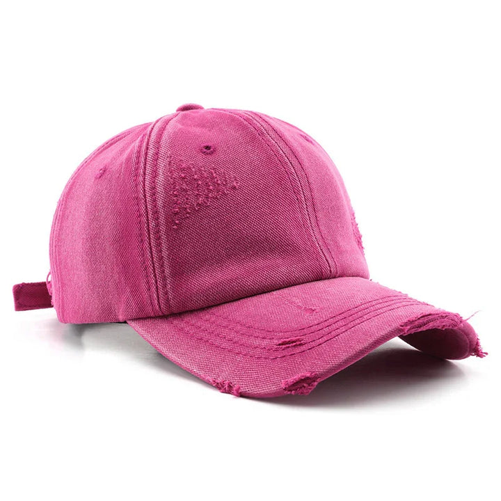 Pink distressed cotton baseball cap with curved brim and adjustable strap