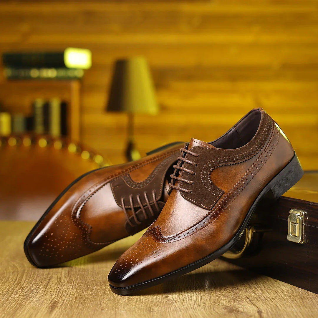 Brown men's leather brogue dress shoes with lace-up design on wooden surface