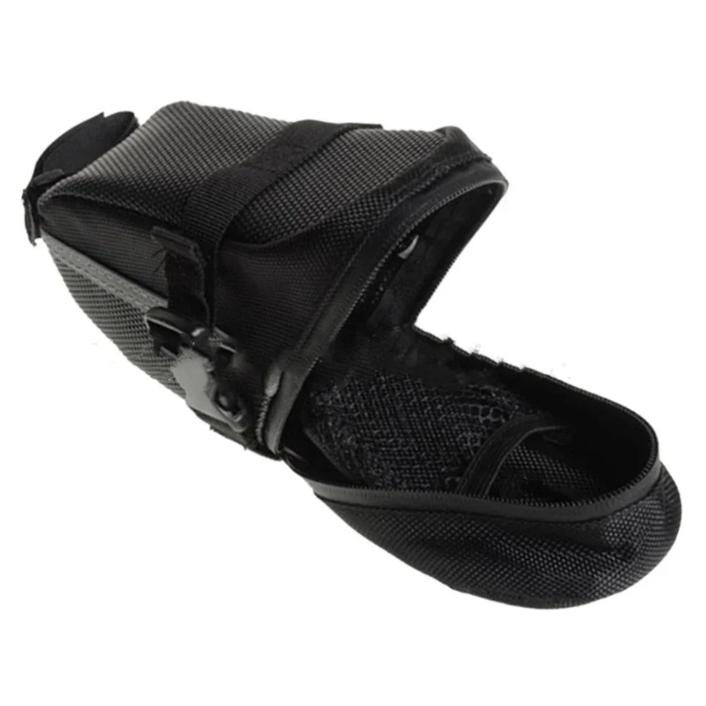 Black mesh and nylon dog muzzle with adjustable straps on white background