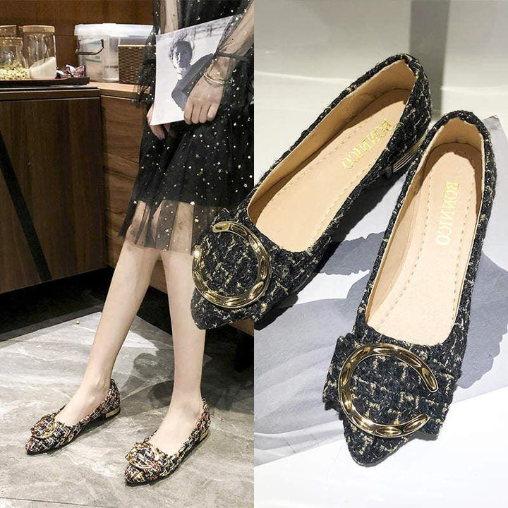 Black tweed pointed flat shoes with gold buckle detail worn by a model in a black star-patterned sheer skirt