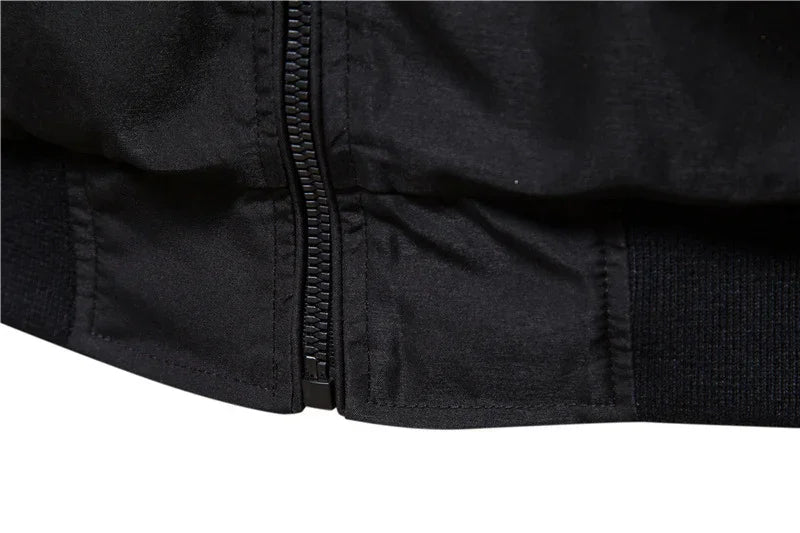 Close-up of black jacket bottom hem with zipper and ribbed elastic band