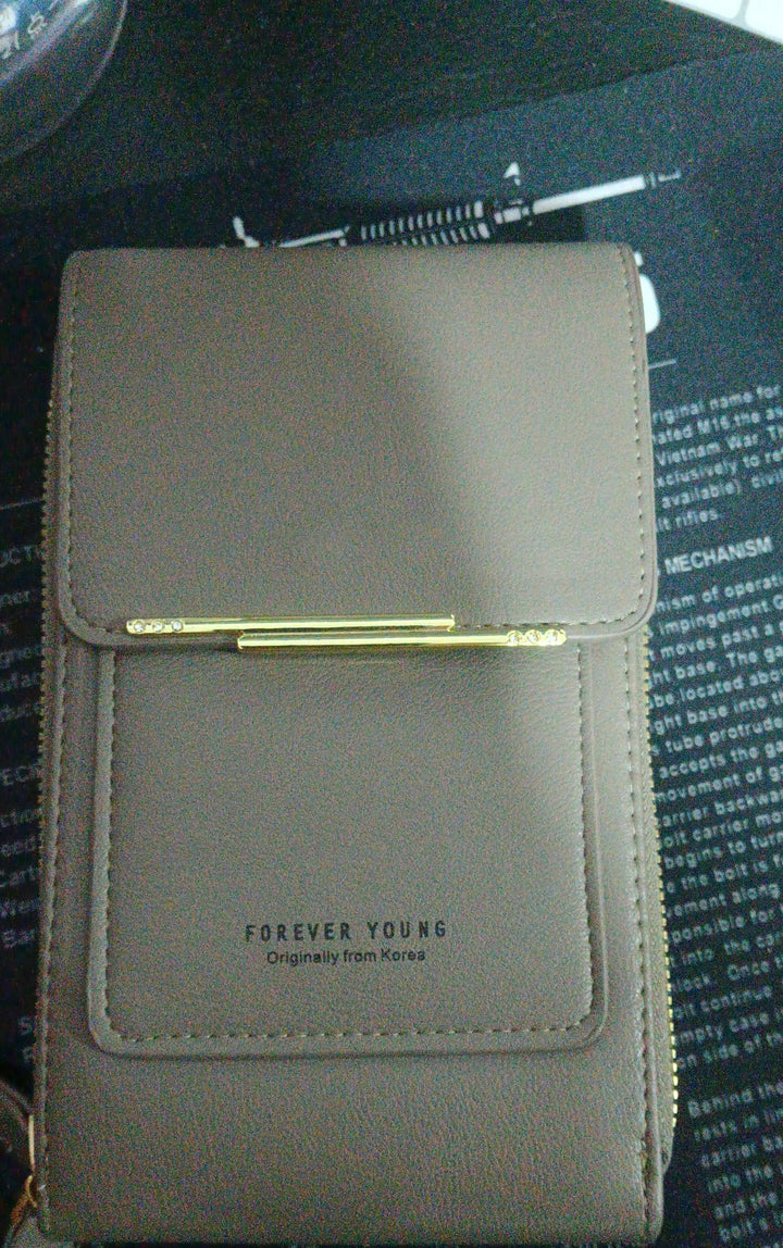 Gray Forever Young leather wallet with gold clasp on black printed background