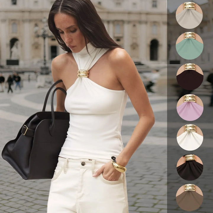 Woman in white halter top and cream pants carrying black bag outdoors with fabric color swatches
