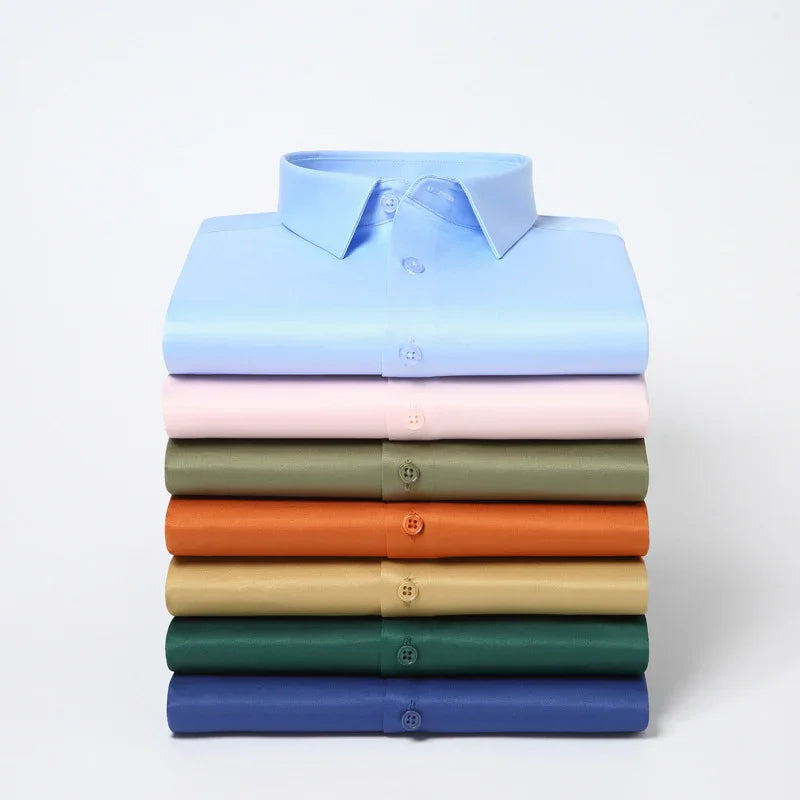 Stack of neatly folded men's dress shirts in pastel and earthy colors including blue, pink, olive, orange, beige, green, and navy