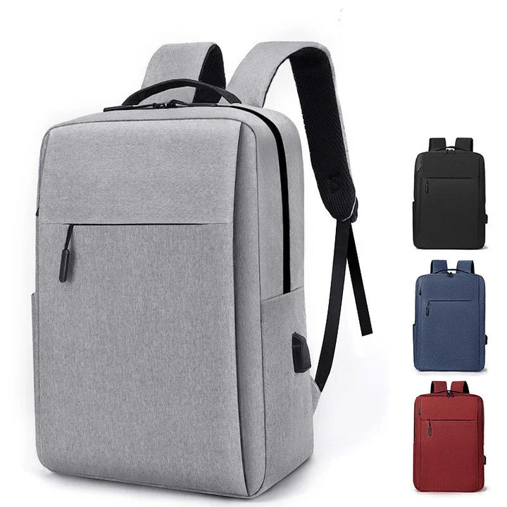Modern grey backpack with black zipper, USB port, and padded straps shown with black, blue, and red variants