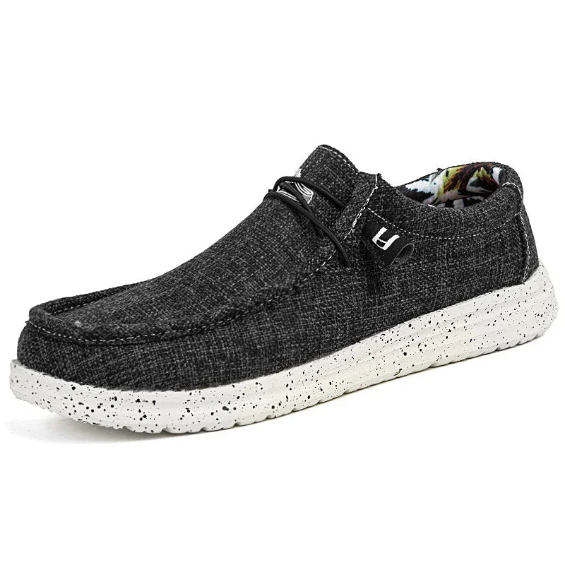 Black textured casual slip-on shoe with white speckled sole and floral inner lining