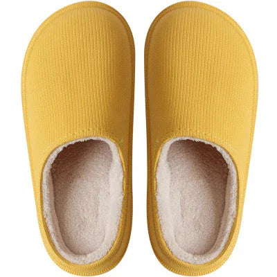 Top view of cozy yellow slippers with soft white fleece lining for indoor wear