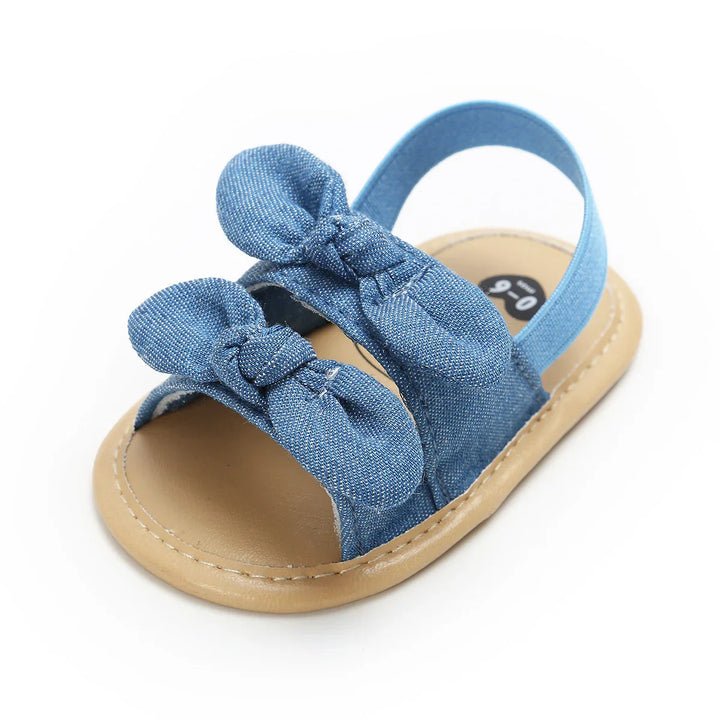 Blue denim baby sandal with bow accents and tan sole, size 9-0